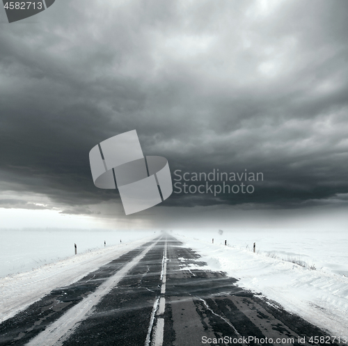 Image of Stormy sky and snow road