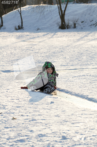 Image of Boy Sliding on Ice Rink