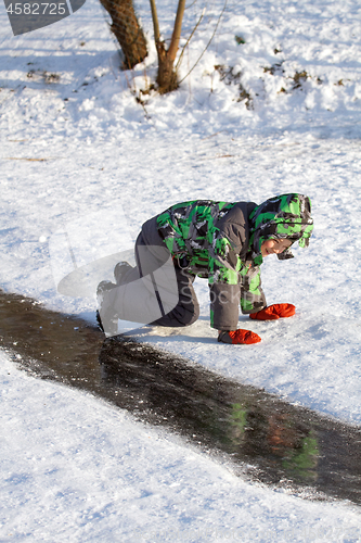 Image of Boy Sliding on Ice Rink