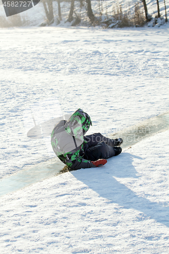 Image of Boy Sliding on Ice Rink