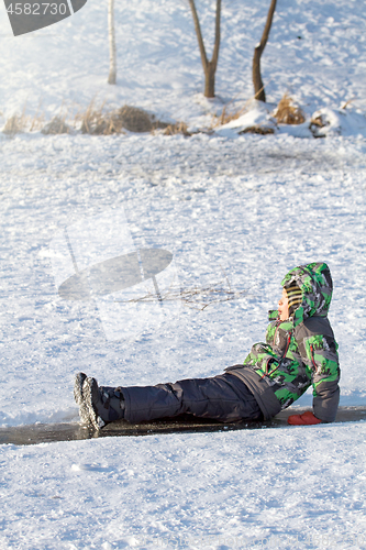 Image of Boy Sliding on Ice Rink