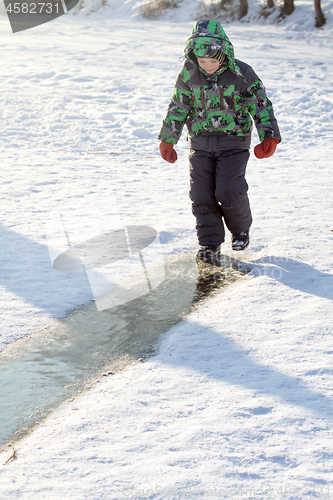 Image of Boy Sliding on Ice Rink