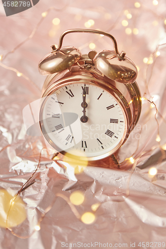 Image of Golden retro alarmclock with exact New Year time.