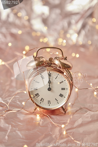 Image of Holiday card with cooper alarmclock and string of lights.