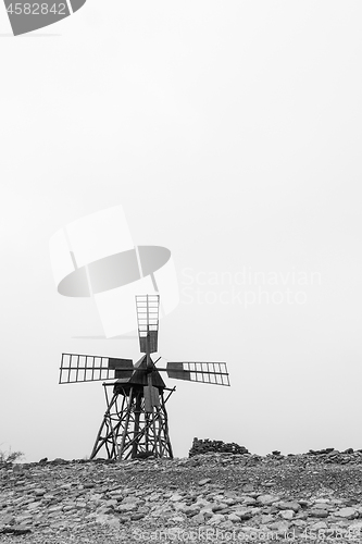 Image of Old wooden windmill in bw