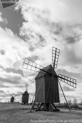 Image of Old wooden windmills line up