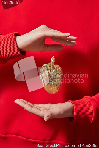 Image of Golden Christmas decoration in the hands.