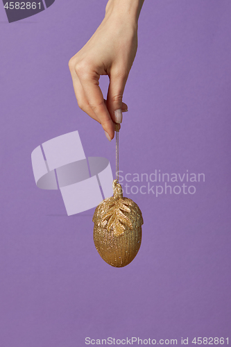 Image of Golden acorn Christmas decoration.