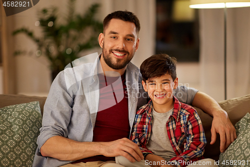 Image of portrait of happy father and little son at home