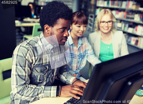 Image of international students with computers at library