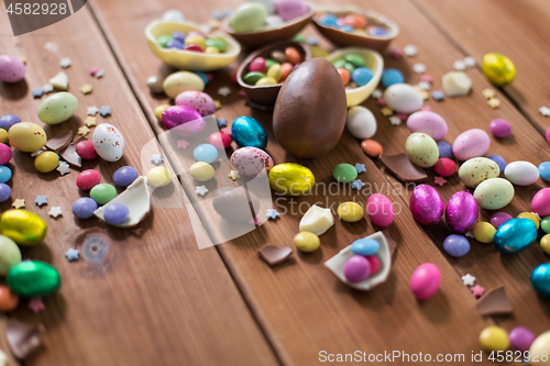 Image of chocolate eggs and candy drops on wooden table