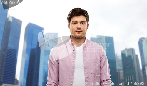 Image of man over singapore city skyscrapers background