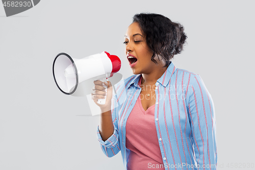 Image of happy african american woman over grey background