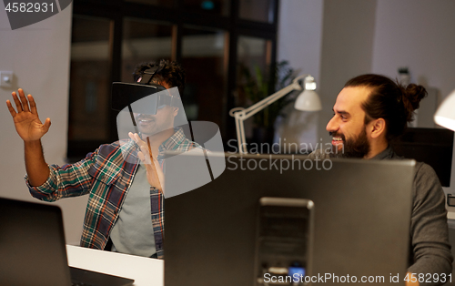 Image of creative man in virtual reality headset at office