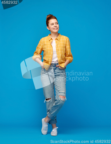 Image of red haired teenage girl in shirt and torn jeans