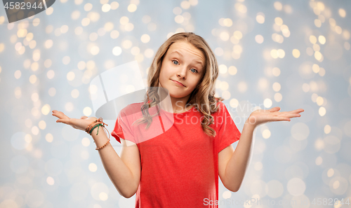 Image of wondering teenage girl in red t-shirt shrugging