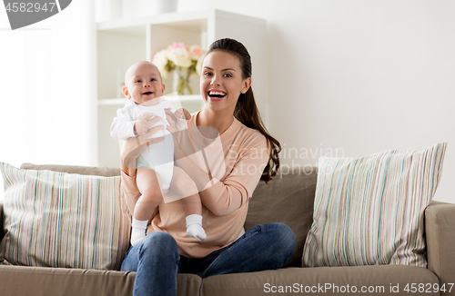 Image of happy mother with little baby boy at home