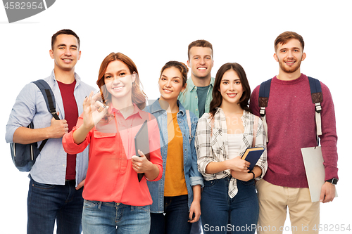 Image of group of smiling students showing ok hand sign