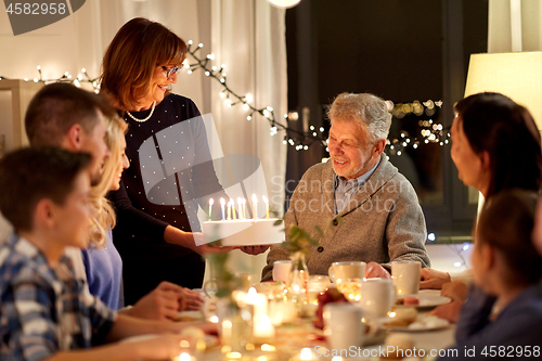 Image of happy family having birthday party at home