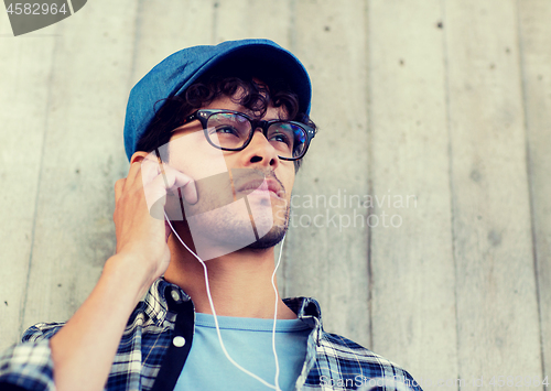 Image of man with earphones listening to music on street