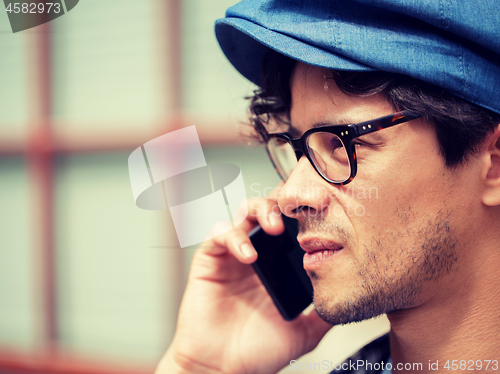 Image of close up of man with smartphone calling on street