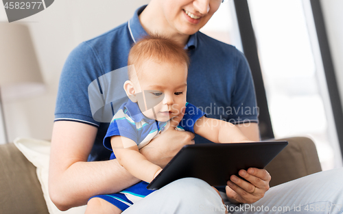 Image of happy father and baby son with tablet pc at home