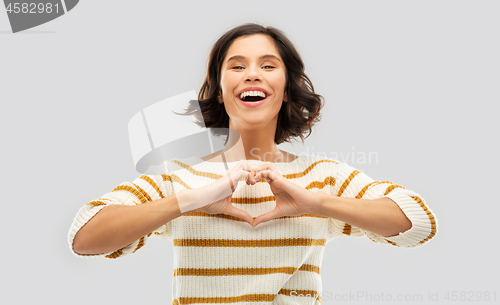 Image of happy smiling woman in striped pullover