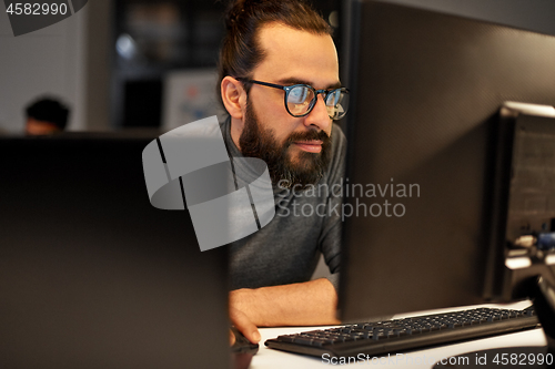 Image of close up of creative man working at night office