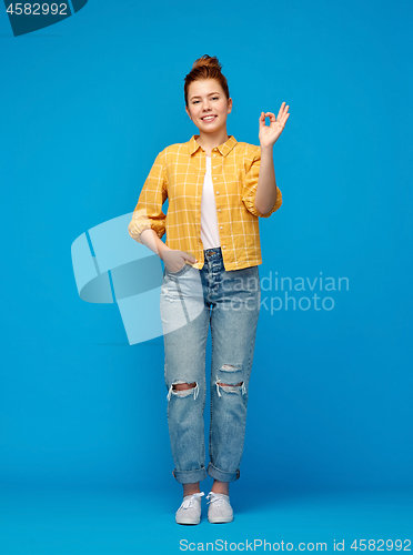 Image of happy red haired teenage girl showing ok hand sign