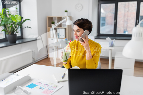 Image of ui designer calling on smartphone at office