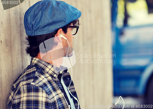 Image of man with earphones and smartphone listening music