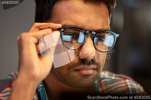 Image of close up of creative man working at night office