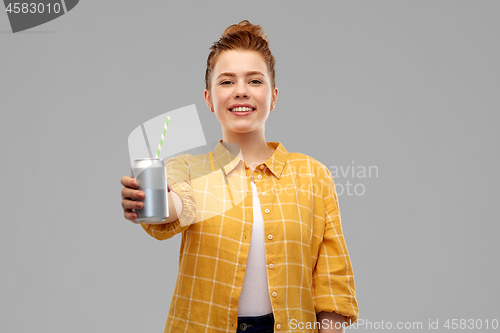 Image of young woman or teenage girl drinking soda from can