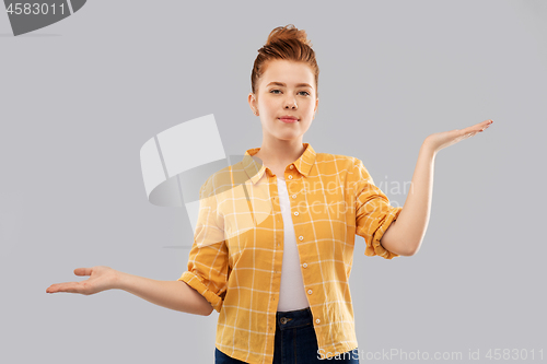 Image of red haired teenage girl holding empty hands