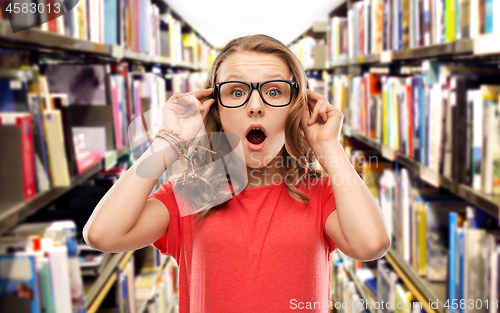 Image of surprised student girl in glasses at library