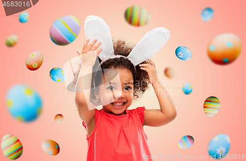 Image of happy little girl wearing easter bunny ears