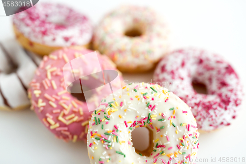 Image of close up of glazed donuts on white table