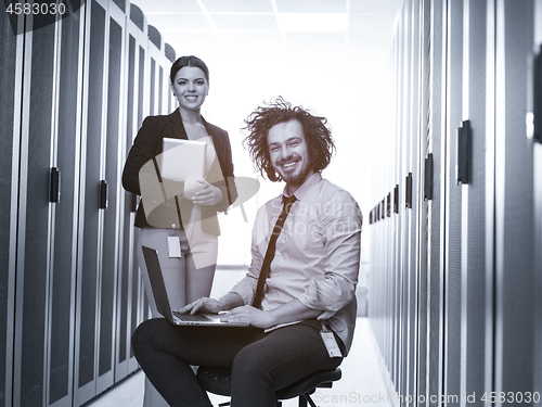 Image of Team of young technicians working together on servers