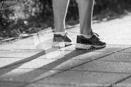 Image of woman jogging at sunny morning