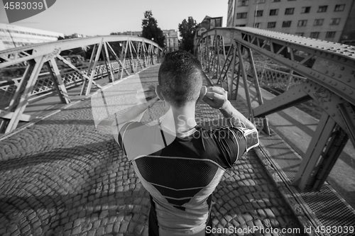 Image of portrait of a jogging man at sunny morning