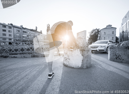 Image of man tying running shoes laces