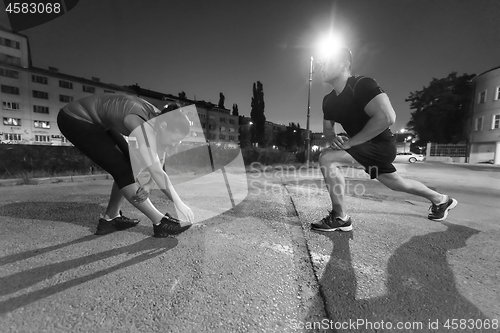 Image of couple warming up and stretching