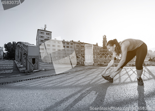 Image of athlete woman warming up and stretching