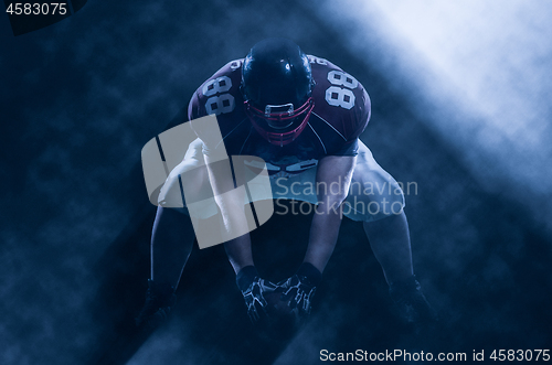 Image of American football player starting football game