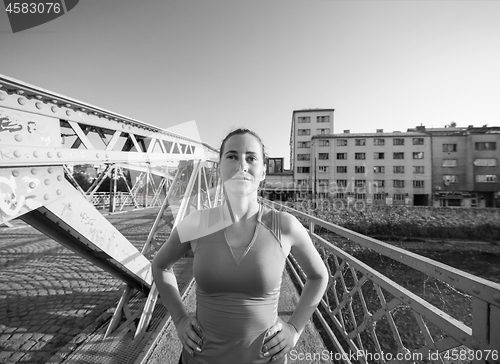 Image of portrait of a jogging woman at sunny morning