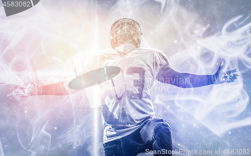 Image of american football player celebrating after scoring a touchdown