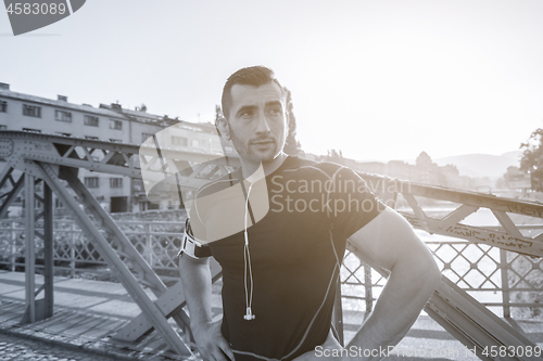 Image of portrait of a jogging man at sunny morning