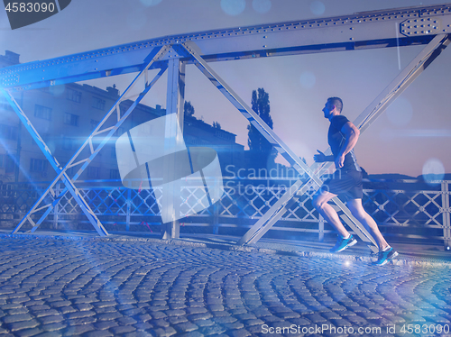 Image of man jogging across the bridge in the city