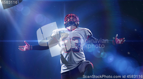 Image of american football player celebrating after scoring a touchdown