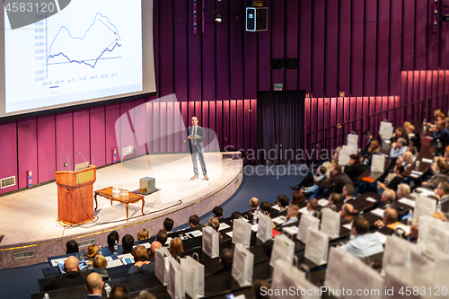 Image of Speaker giving presentation on business conference event.